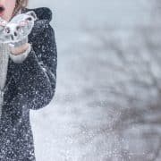 Young Hamilton woman collecting snowflakes on snowy Winter day
