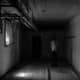 Young man exploring dark, unfinished Hamilton basement