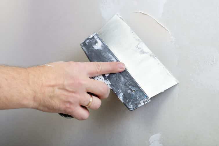 repairman works with plasterboard, plastering dry-stone wall, home improvement