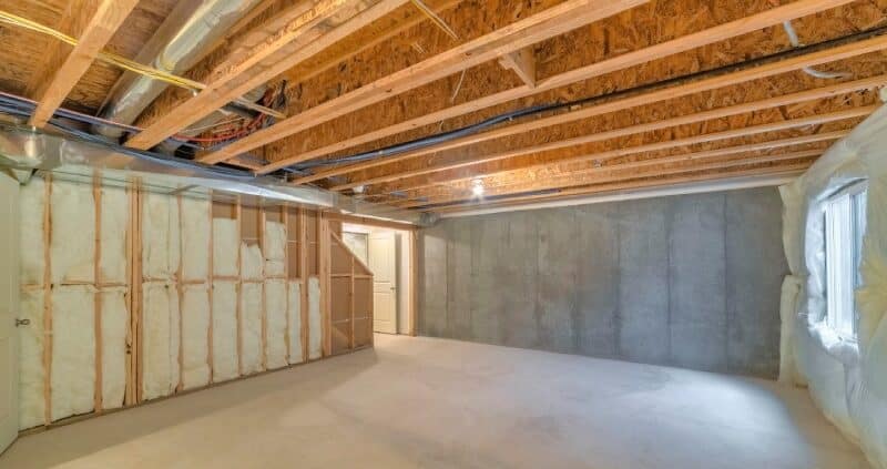 unfinished basement-with-a-plastic vapor barrier on the wall